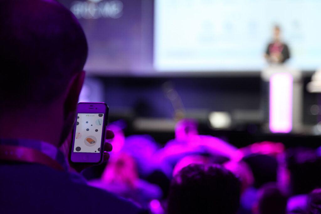 An audience member opens his phone to Duelbox - one of the top event companies in Hungary