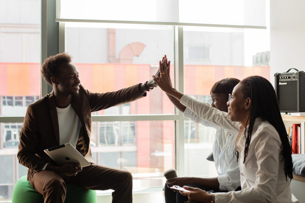 Coworkers high five after playing an interactive  game
